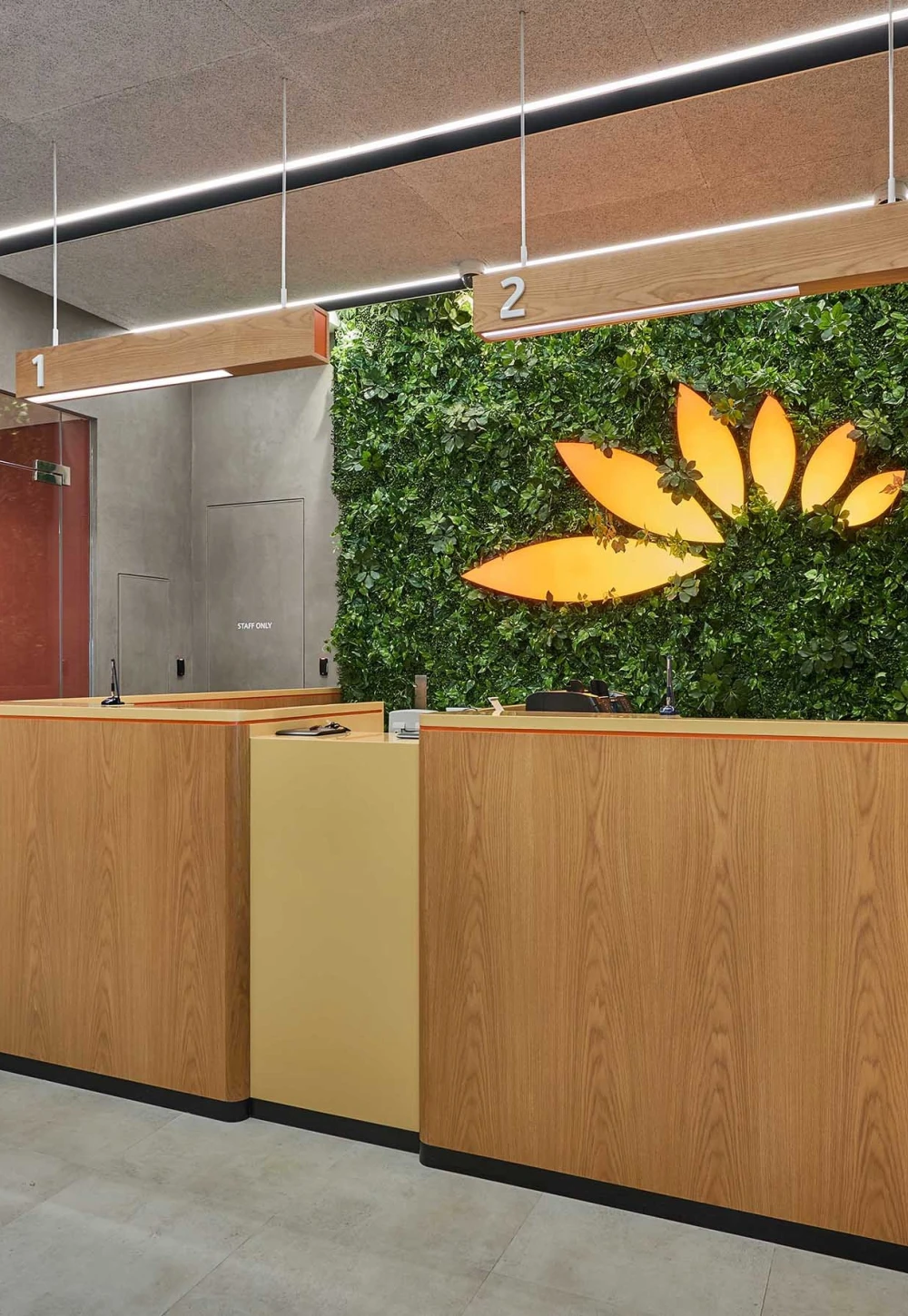 a green wall in use behing a reception desk